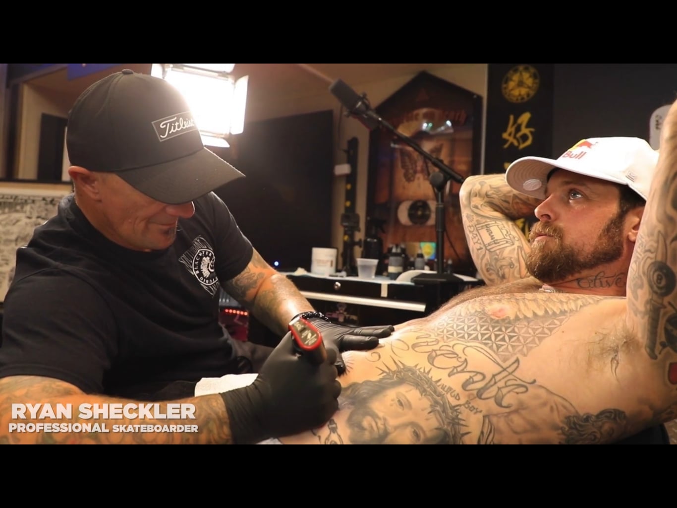 Tattoo artist with client