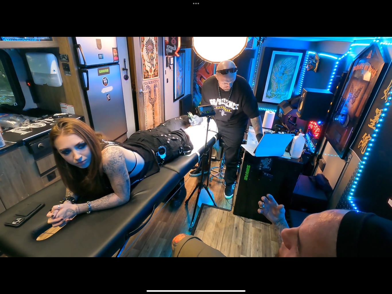 Tattoo artist working with client